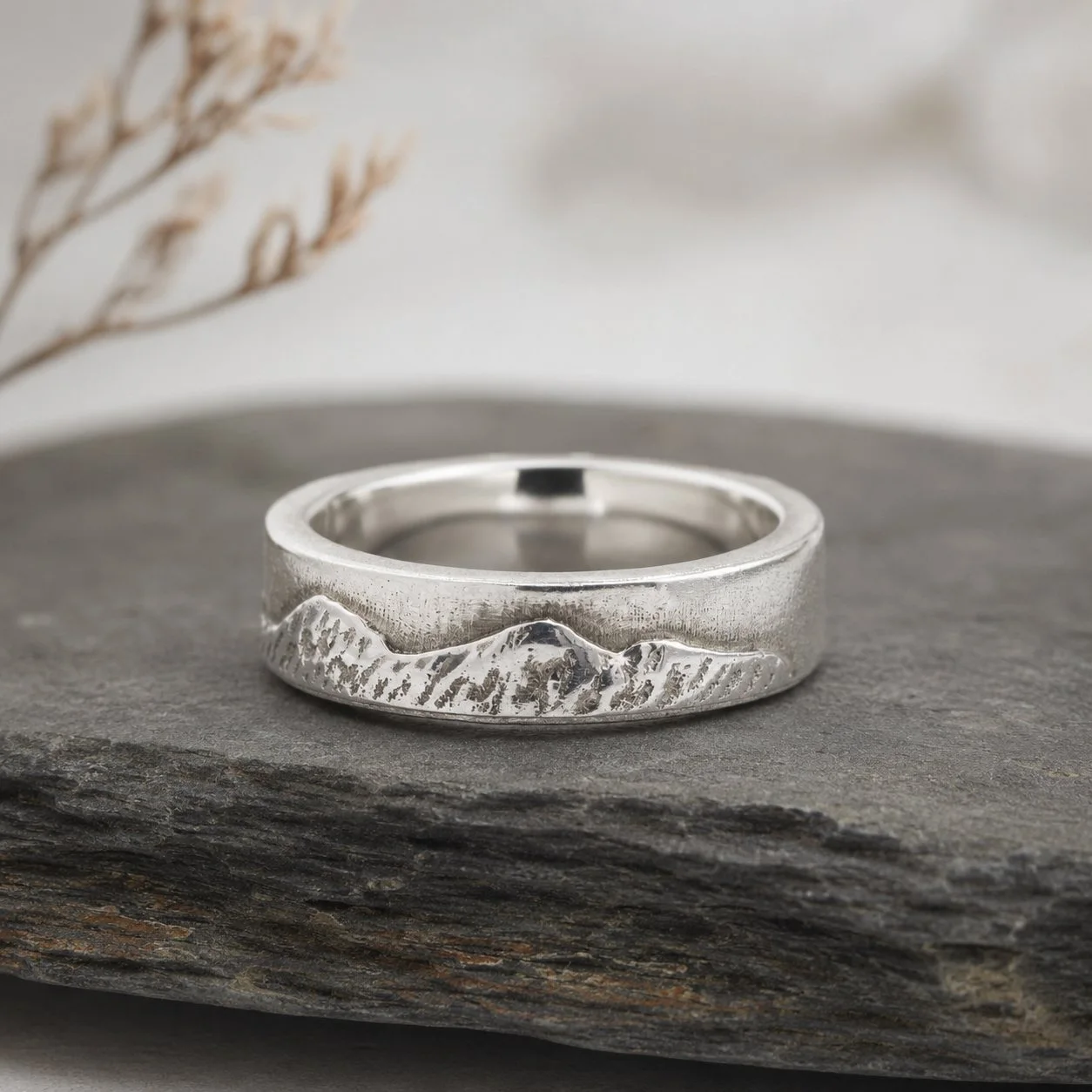 National Three Peaks ring standing on dark slate, the cast ridgeline running the full width of the band.