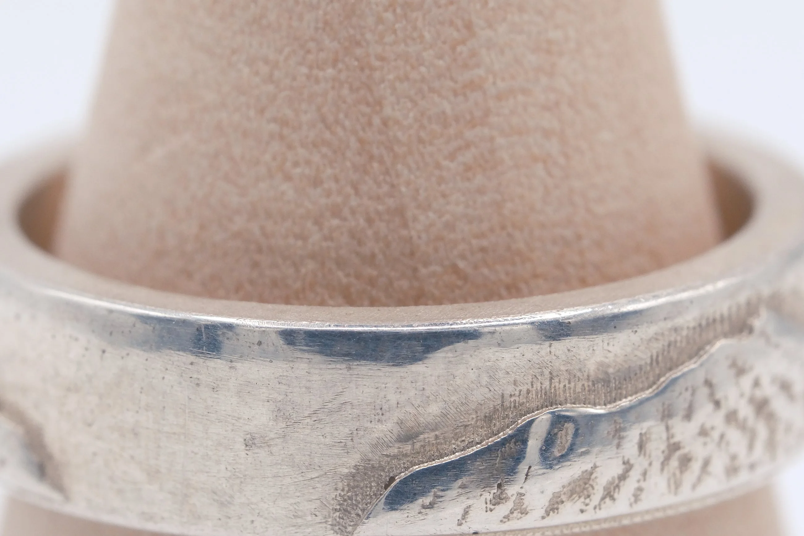 Macro view of the cast surface texture and the polished edge running above it.