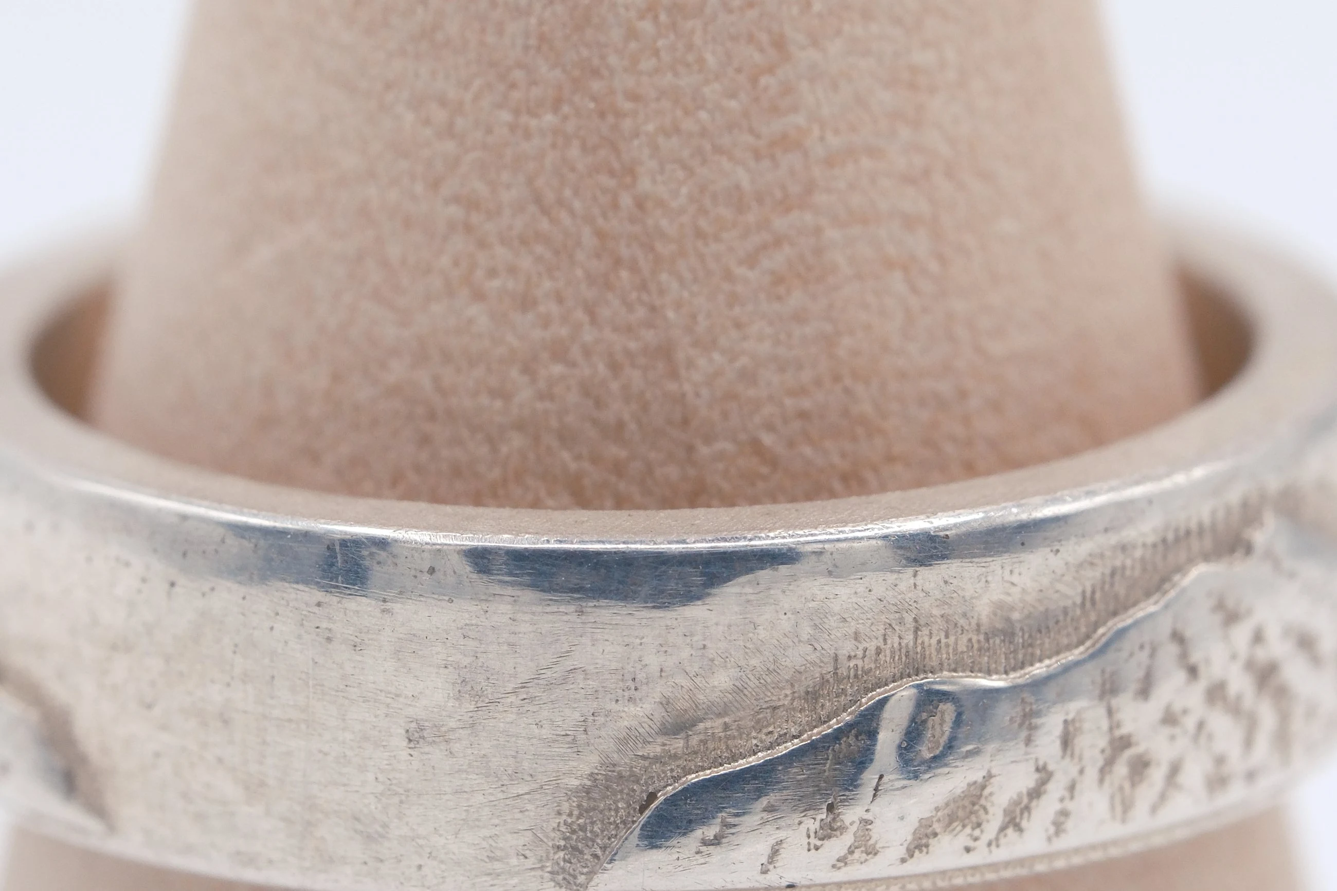 Macro view of the cast surface texture and the polished edge running above it.